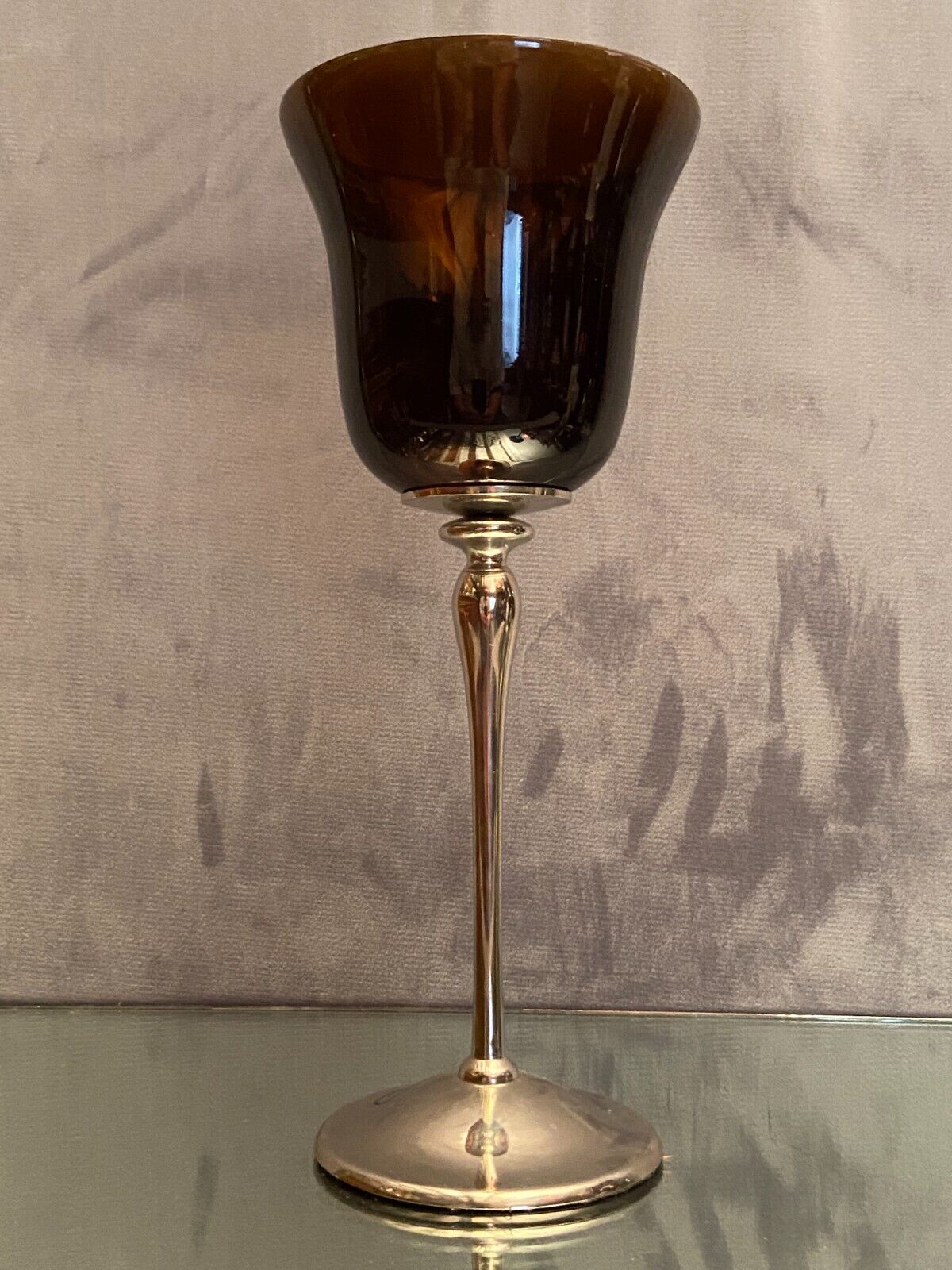 Tinted glass photophore on high metal foot with silver patina