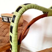1950s 60s rattan armchair with green apple and black piping.