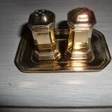 Silver-plated salt and pepper shakers presented on a small tray