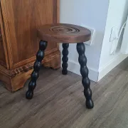 Brown and black wooden tripod stool