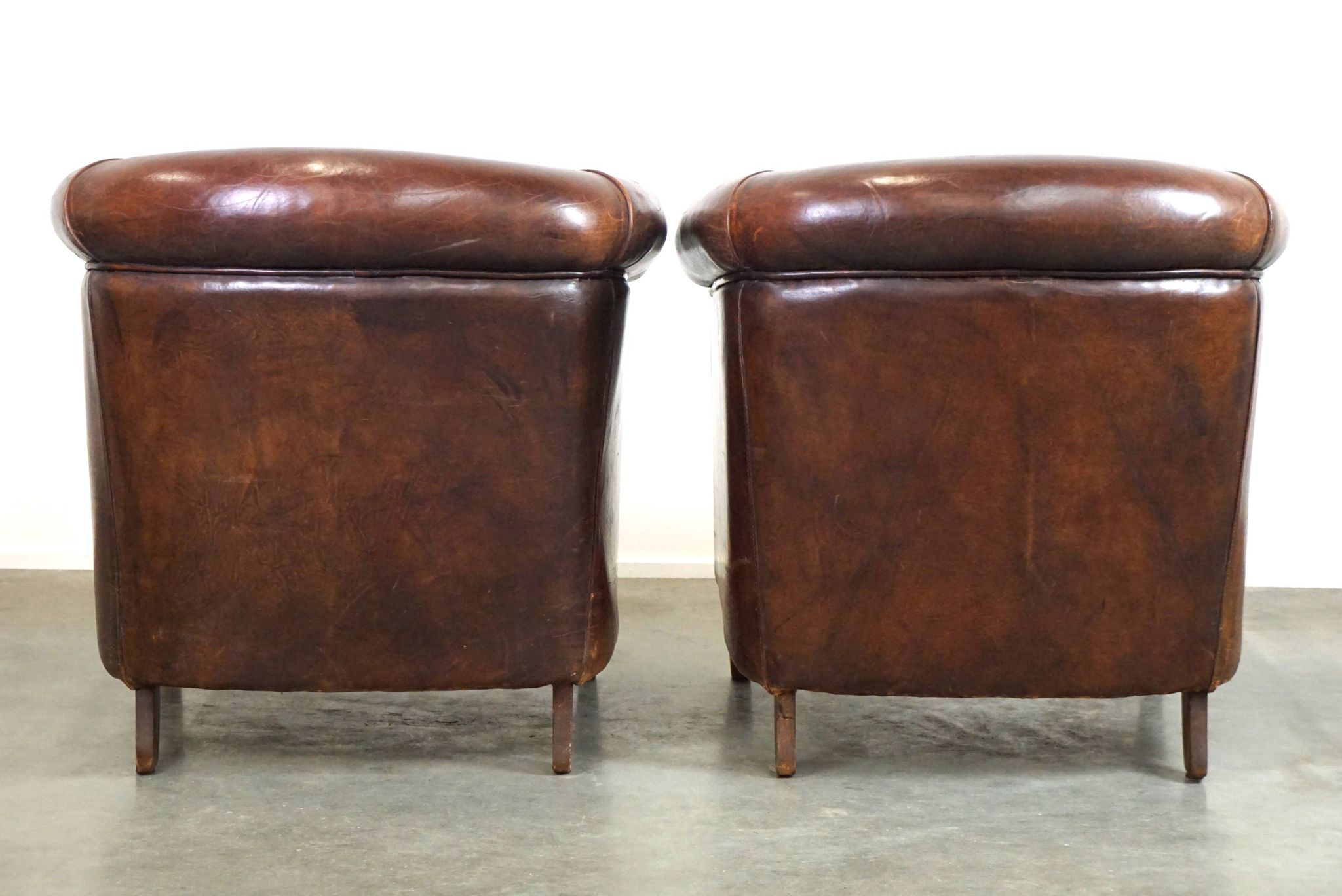 Set of two rugged sheep let of two rugged sheep leather club armchairs with a nice distressed look