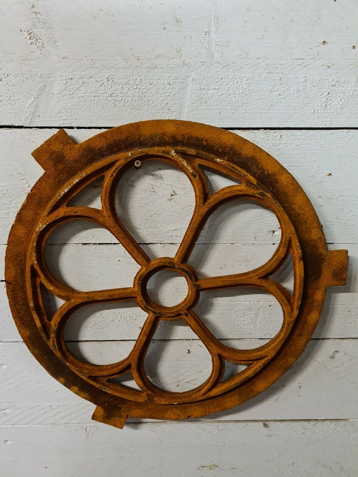 Cast iron ox's eye window in the shape of a flower