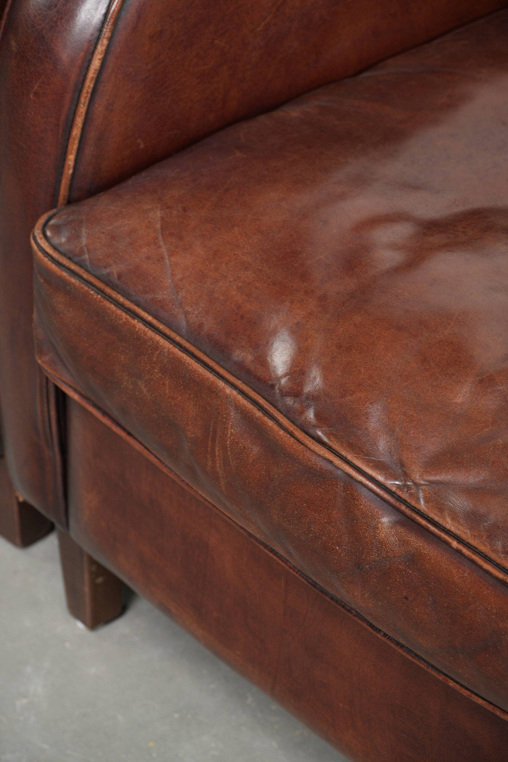 Dark cognac-coloured set of 2 sheepskin armchairs with a sleek design