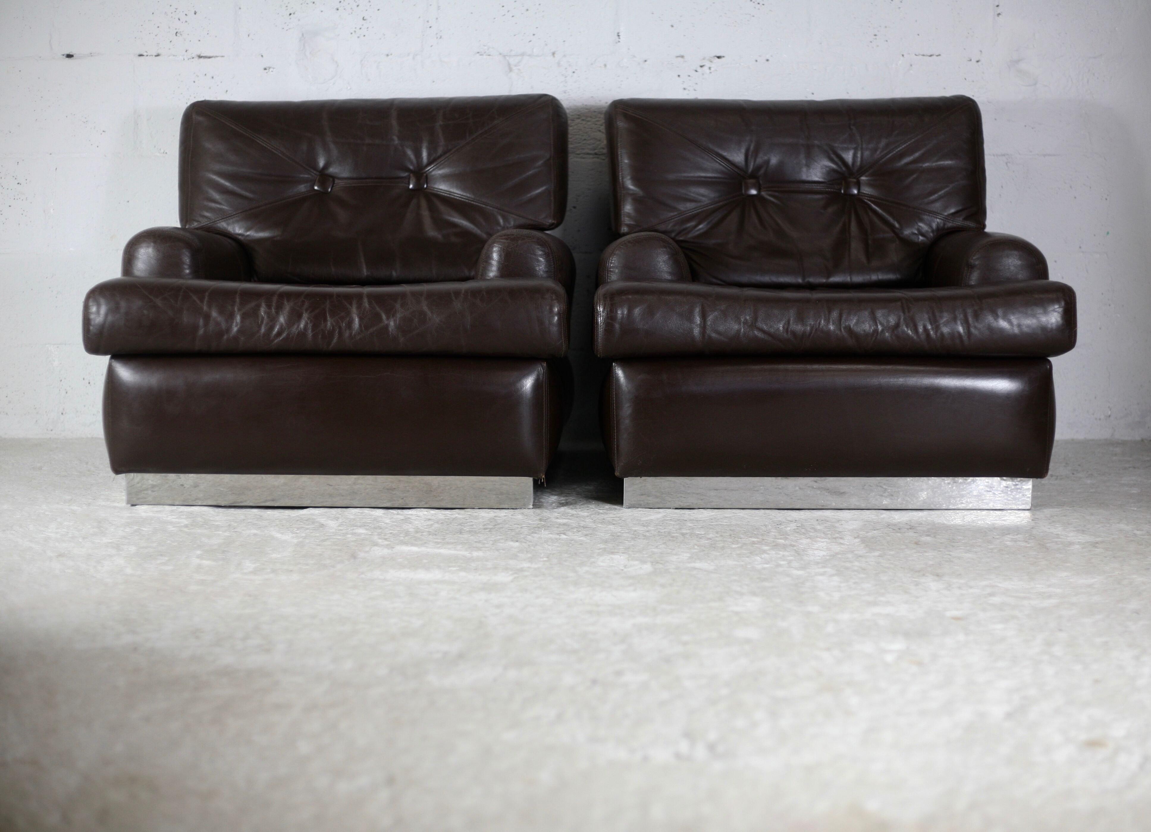 Pair of armchairs brown leather base stainless steel, France, circa 1970