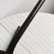Dark brown metal stool, minimalist three-legged design