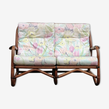 Rattan sofa with flower cushions