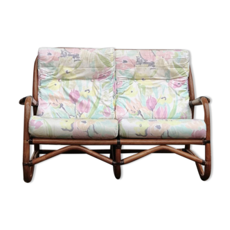 Rattan sofa with flower cushions