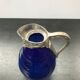 Former pitcher carafe art de blue moulded glass - vintage metal anse