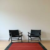 Two numbered black leather designer armchairs – Olivier De Schrijver