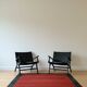 Two numbered black leather designer armchairs – Olivier De Schrijver