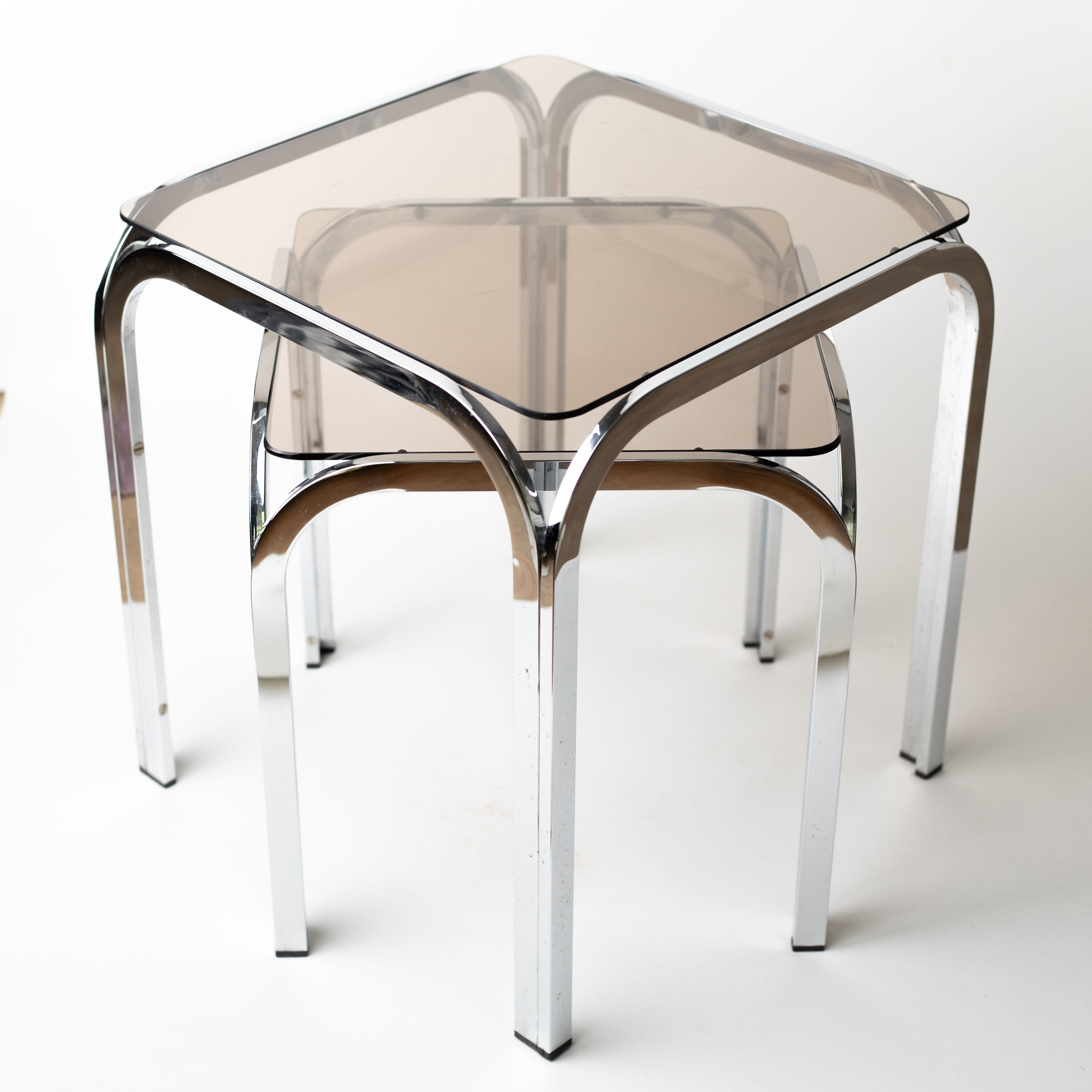 Pair of chrome nesting tables with smoked glass tops