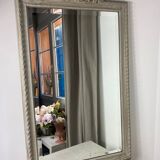 Large antique beveled mirror in carved wood painted with floral decoration and
