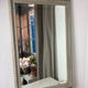 Large antique beveled mirror in carved wood painted with floral decoration and