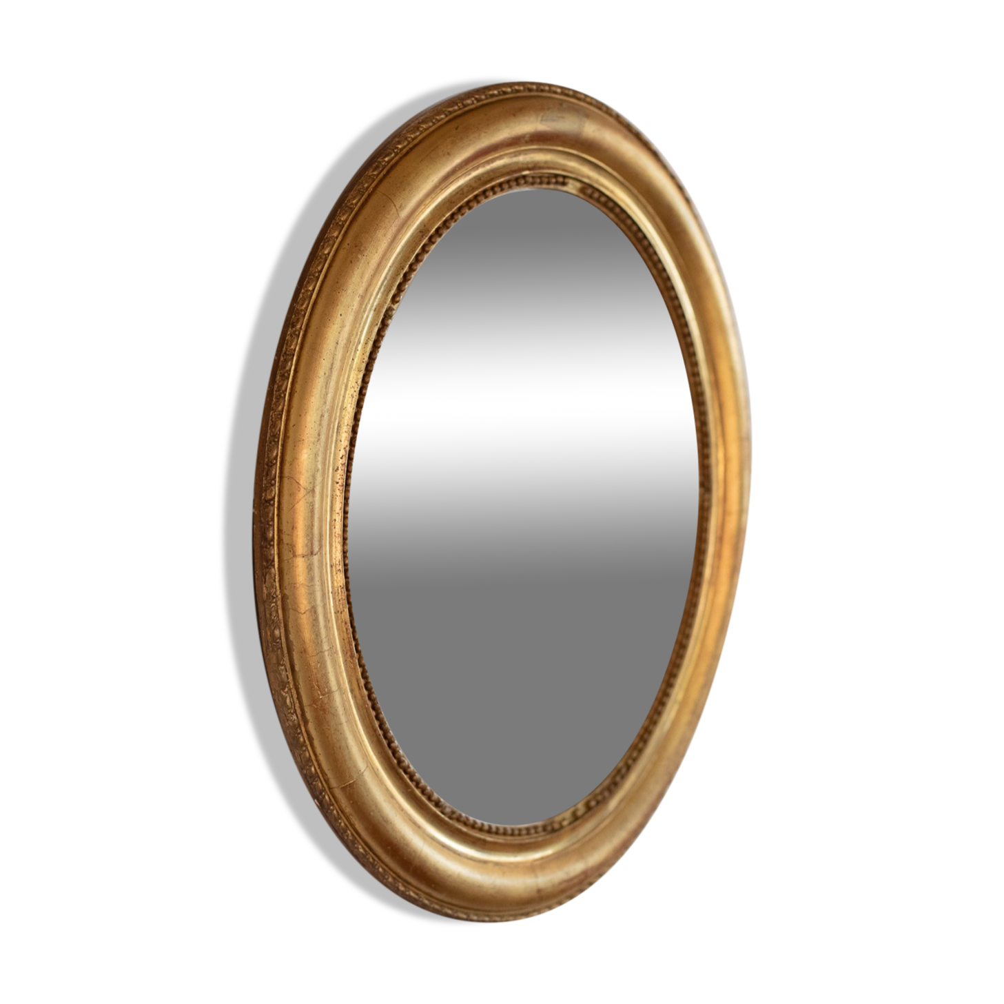 Oval mirror in gilded wood late 19th