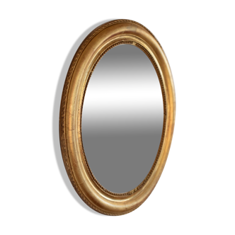 Oval mirror in gilded wood late 19th