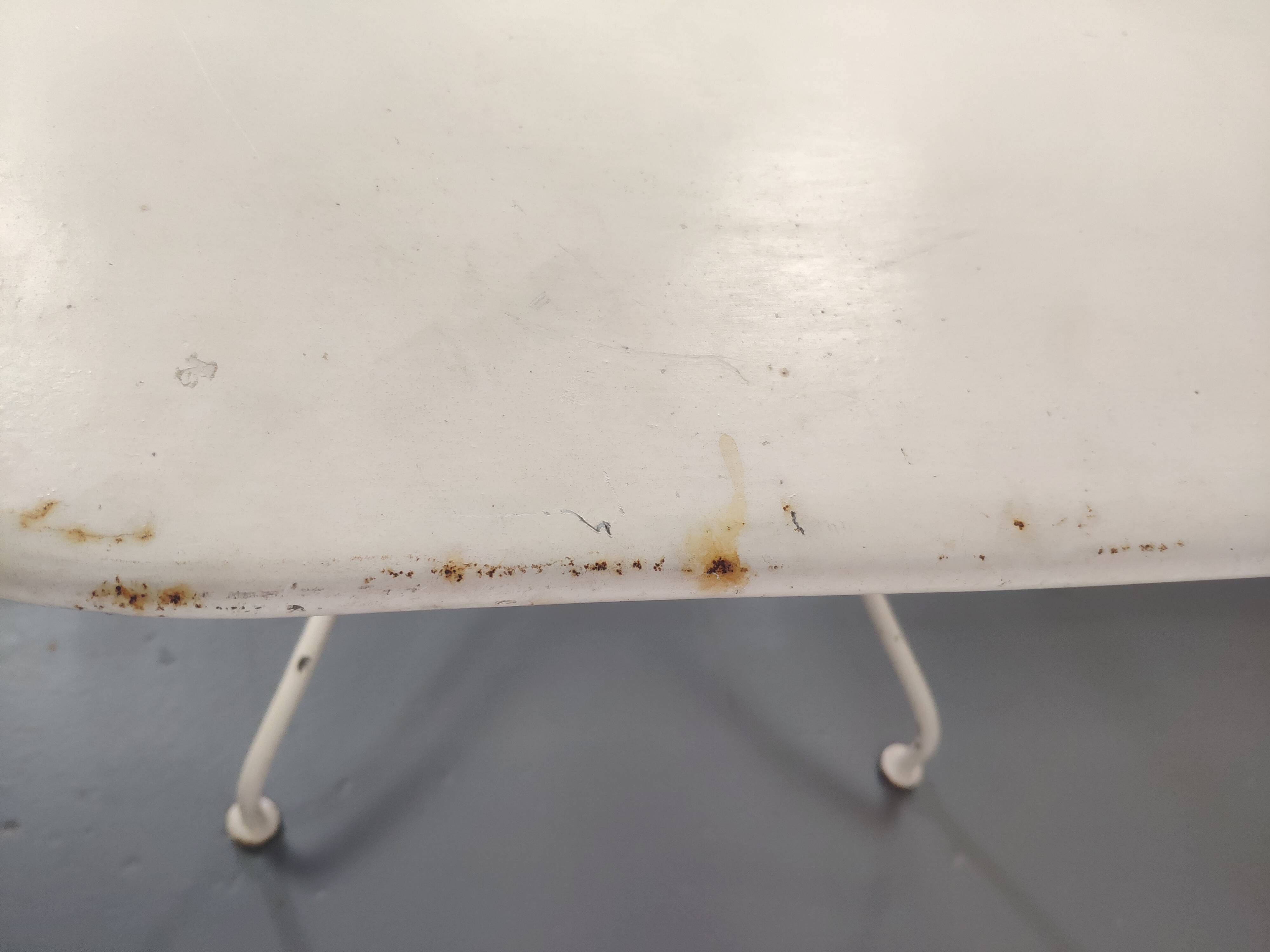 Old folding garden table in white wrought iron