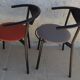 4 gondola-style chairs with a sturdy metal frame and faux leather.