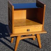 Vintage oak bedside table with tapered legs.
