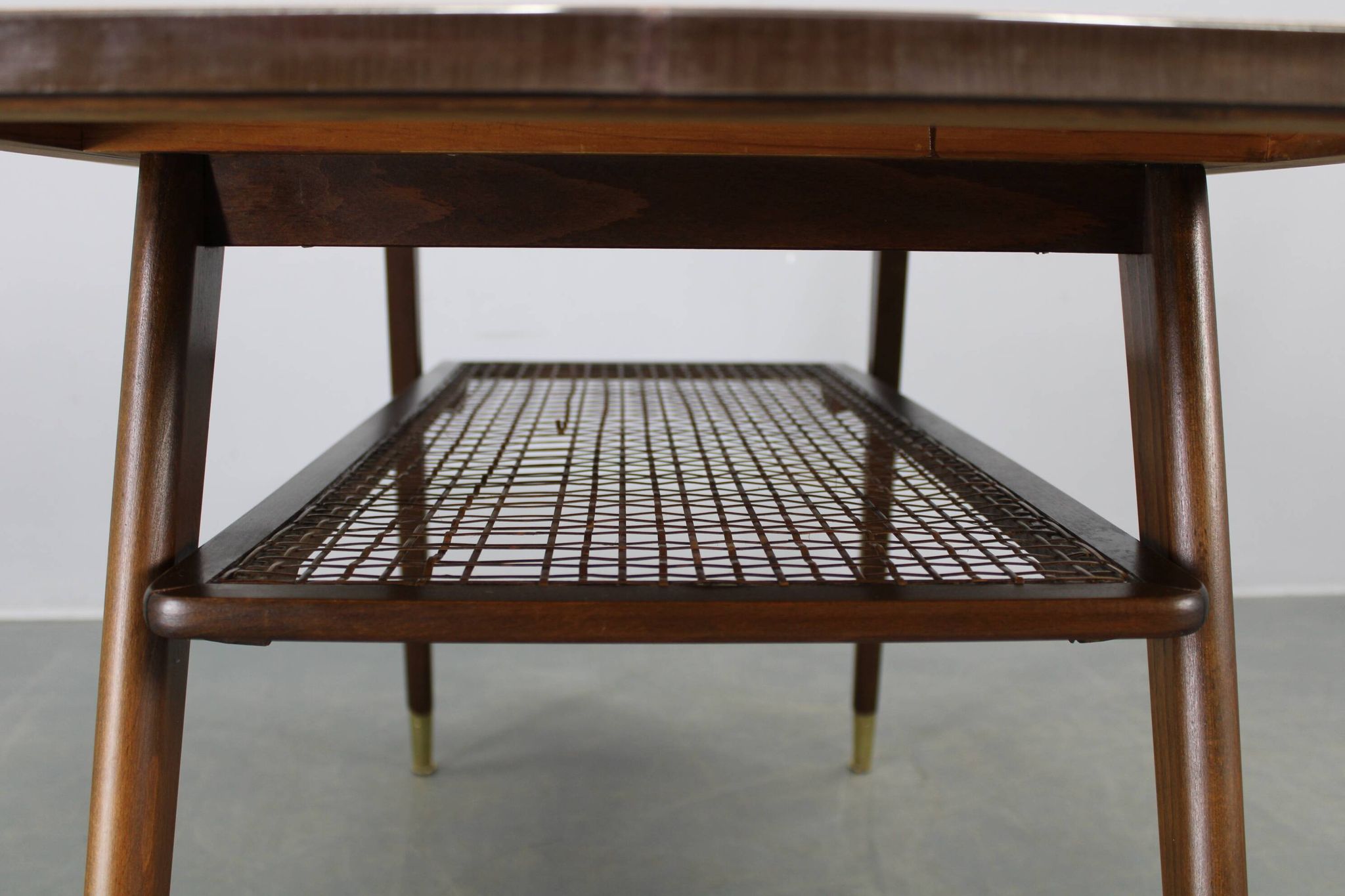 Mid-century German coffee table with rattan shelf and brass legs