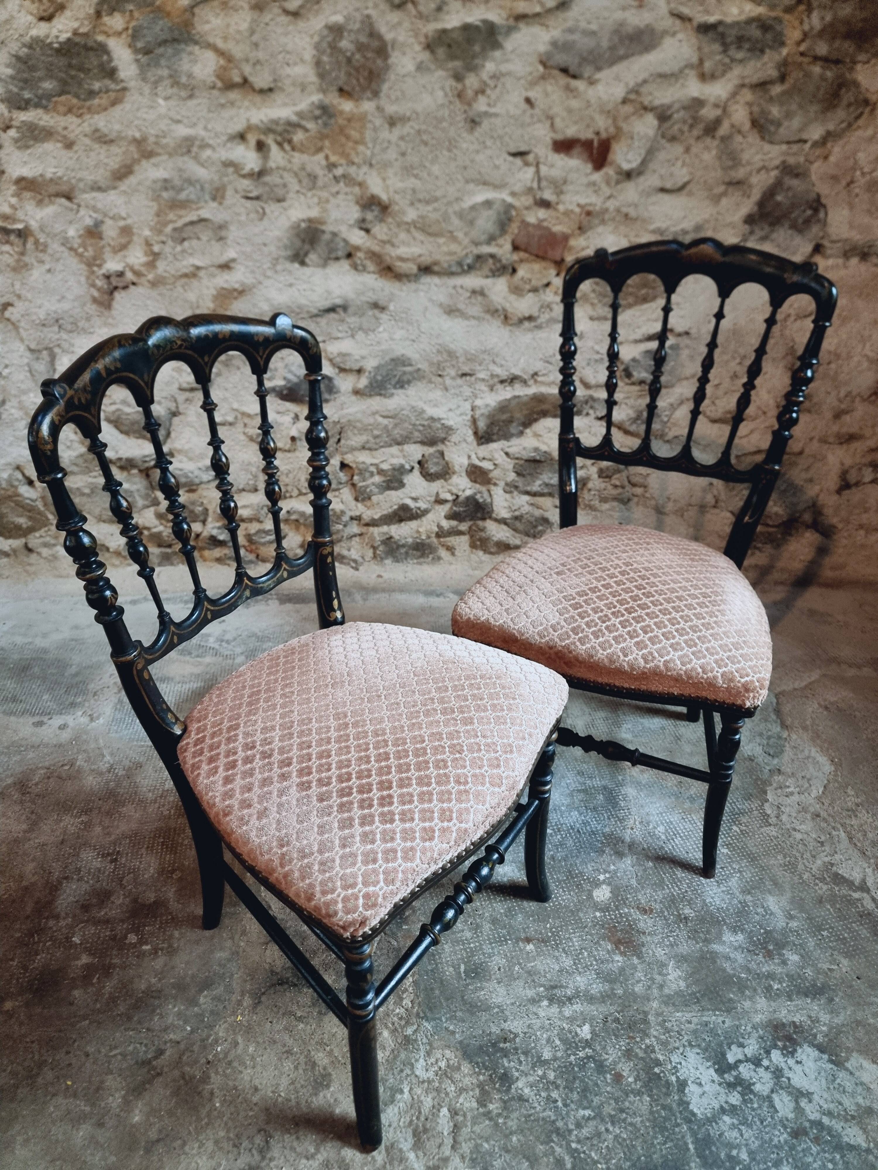Pair of antique Napoleon III chairs in blackened wood and fabric.