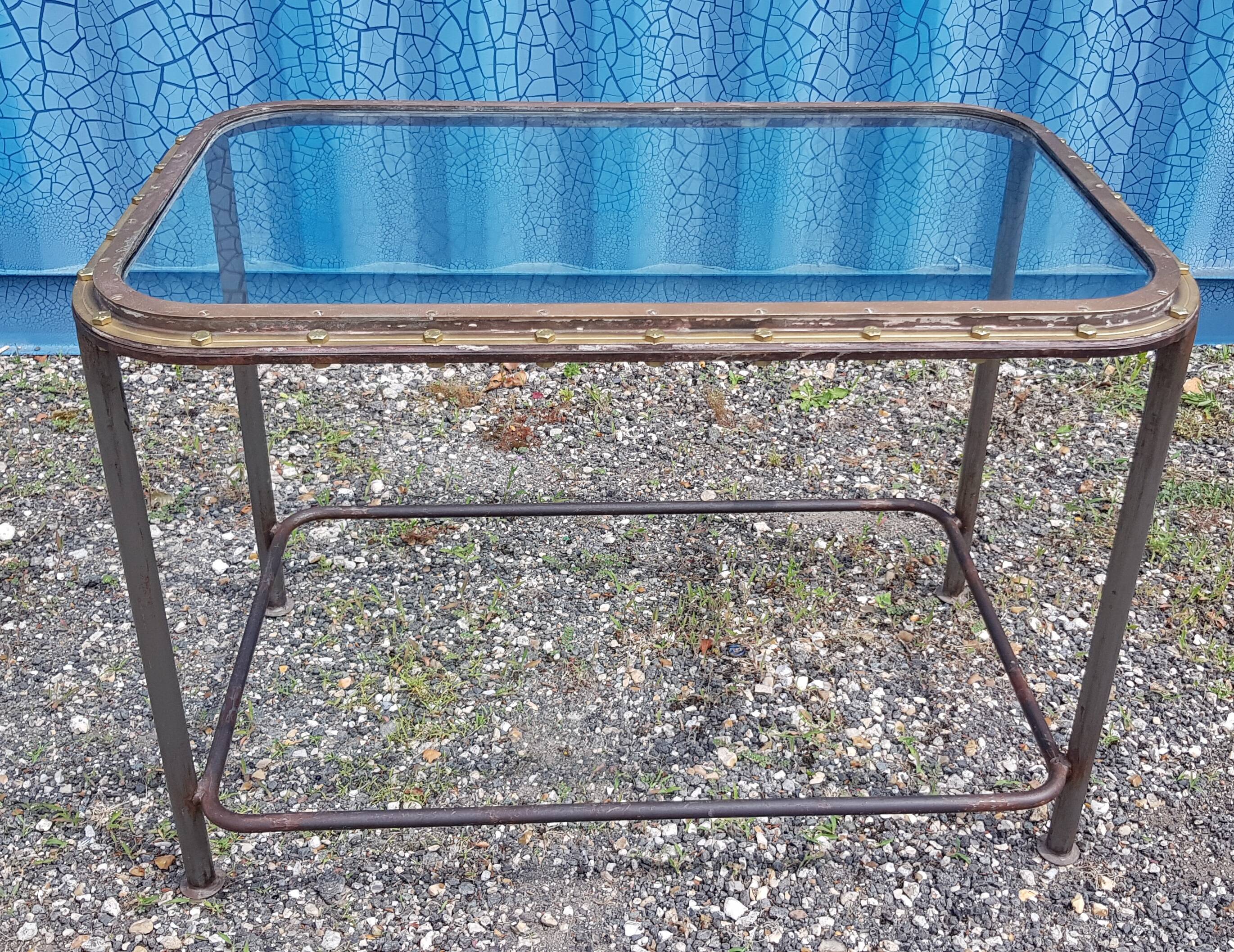Table with an old ship porthole in brass and a metal base / 110 x 70 x 76 cm