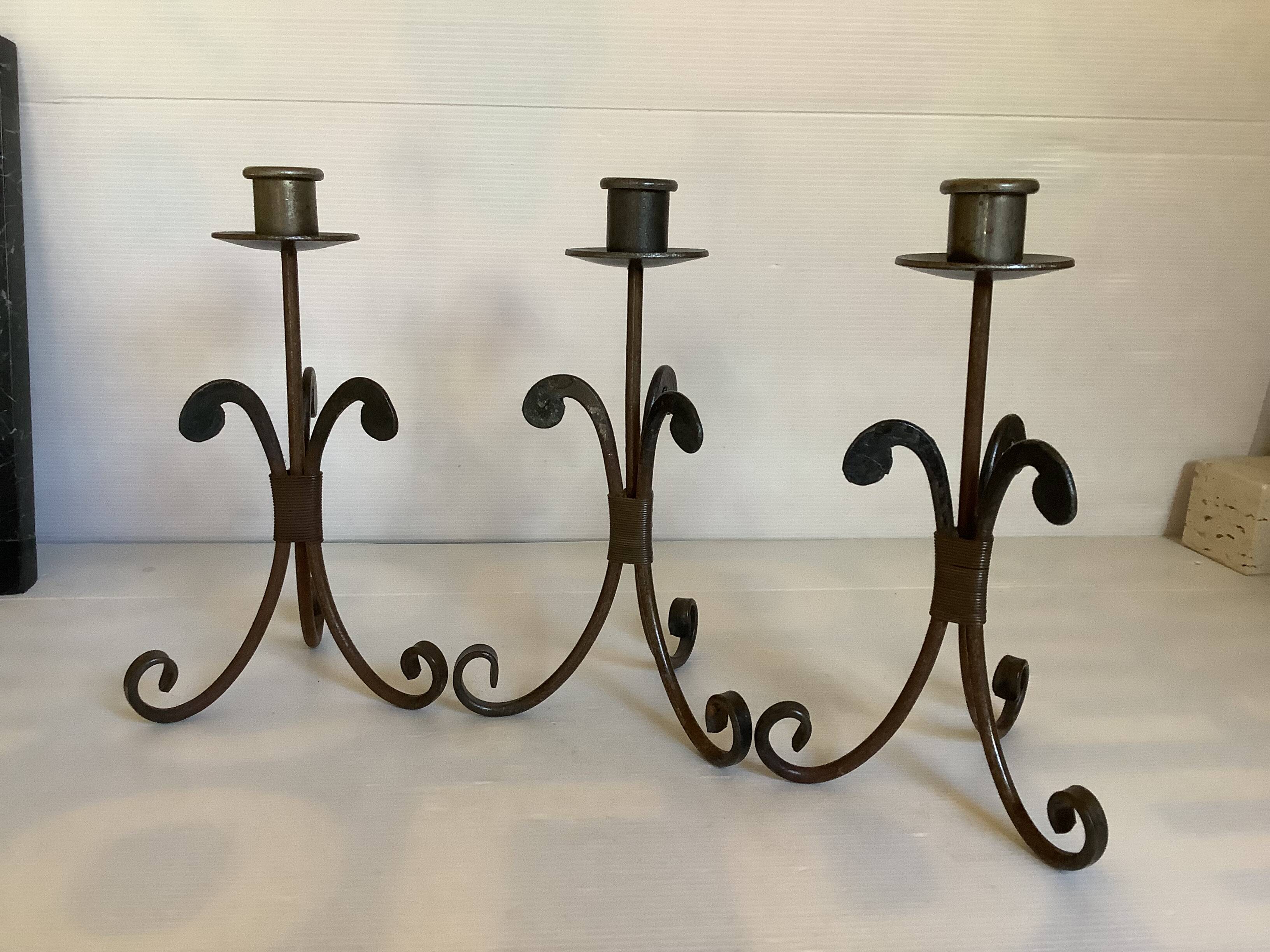 Trio of wrought iron candlesticks