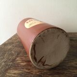 Old bottle in hazelnut Brown sandstone with label