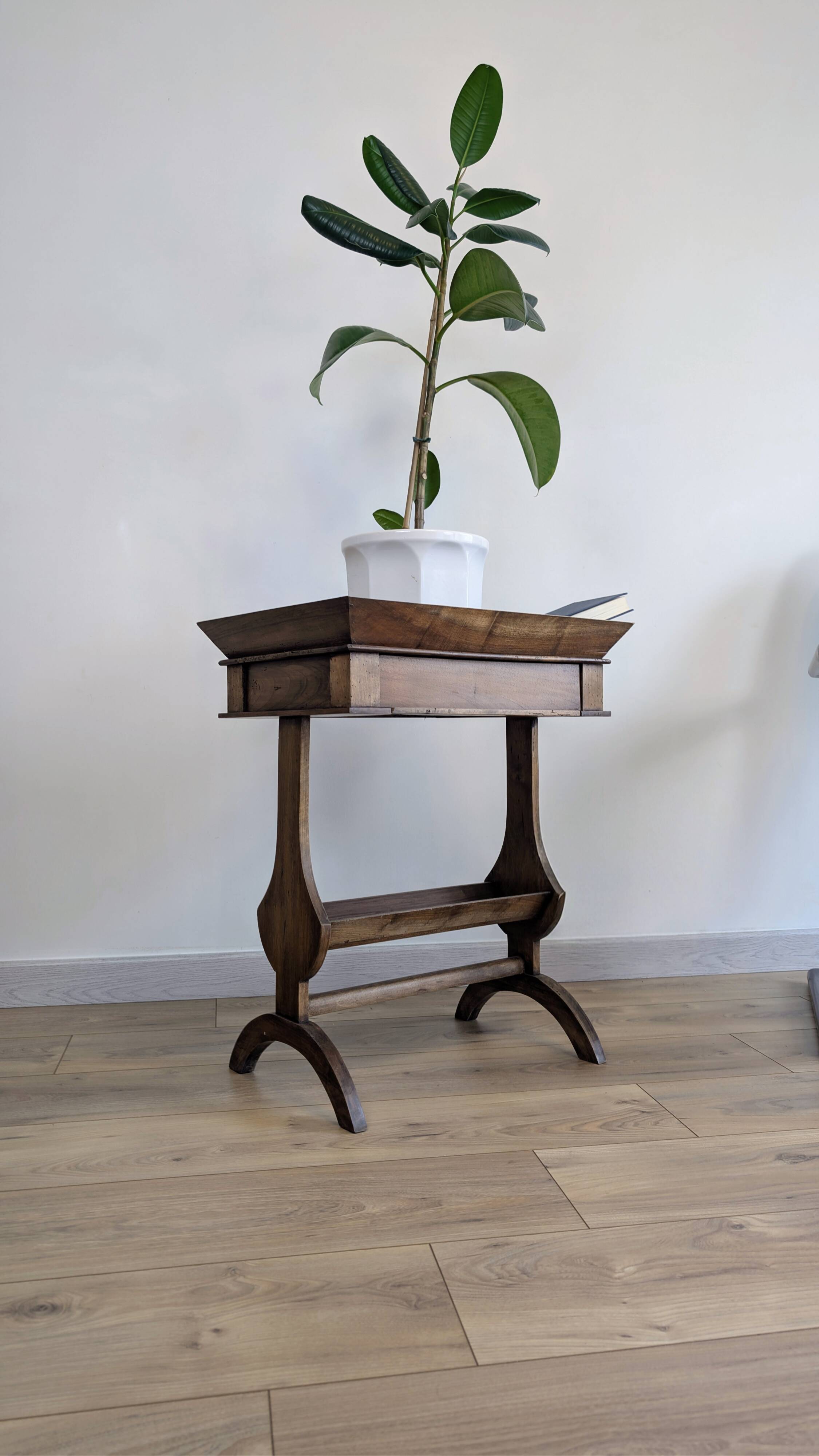 Old wooden pocket emptying table with drawer and planter.
