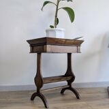 Old wooden pocket emptying table with drawer and planter.