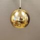 Danish ball lamp from the 80s, in gold colored lacquer.