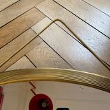 Antique oval beveled mirror adorned with tassels