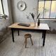 Oak farmhouse table with turned black legs.
