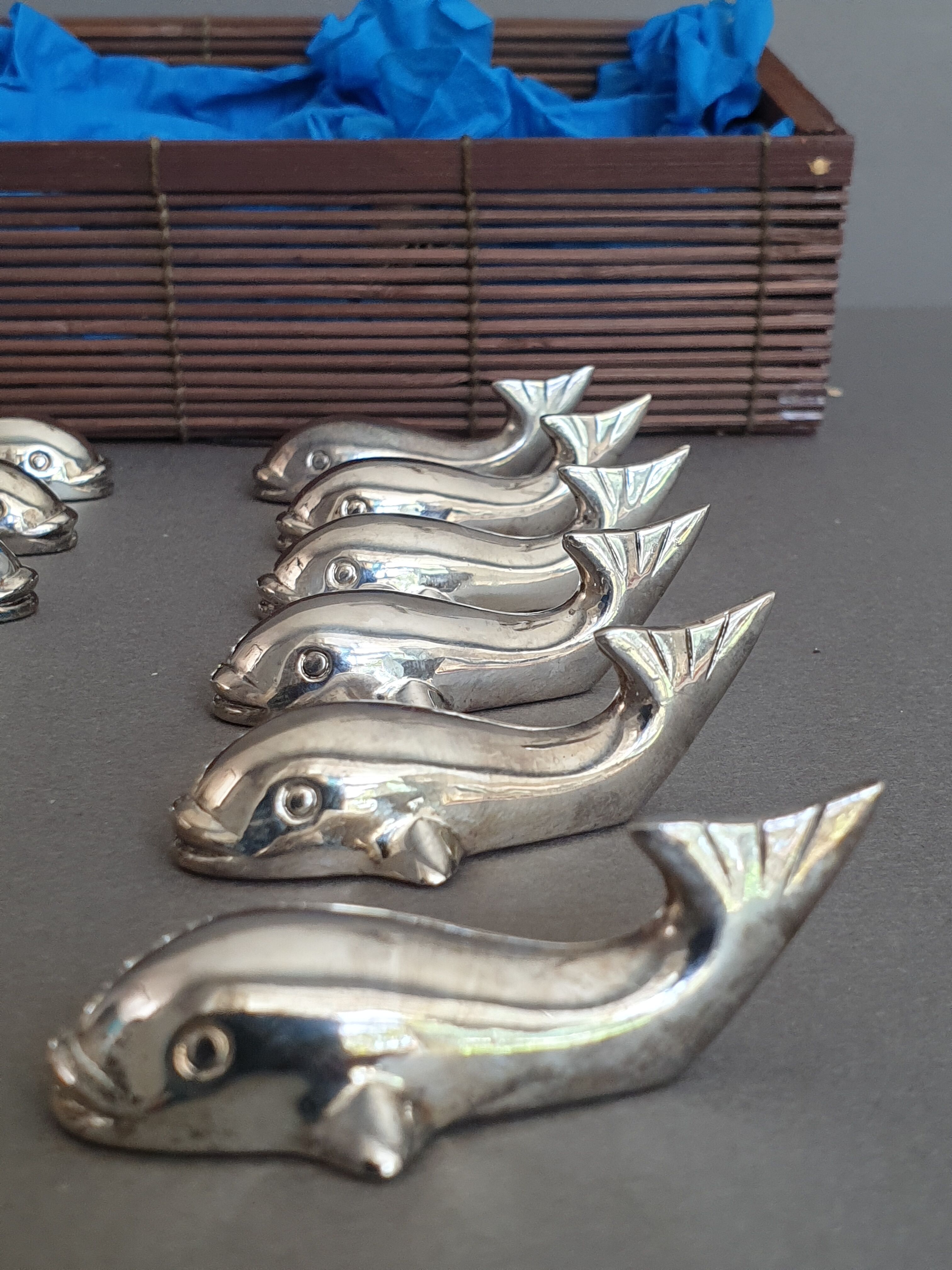 Lot 12 knife holders in the shape of a stylized whale or fish