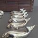 Lot 12 knife holders in the shape of a stylized whale or fish