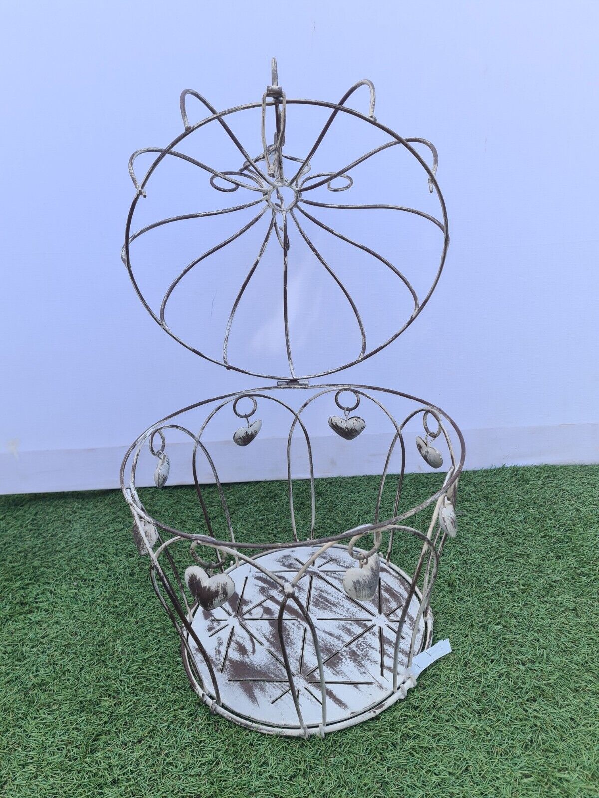 Decorative bird cage with iron hearts