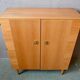Vintage 1960s shoe cabinet in light wood and chrome metal.