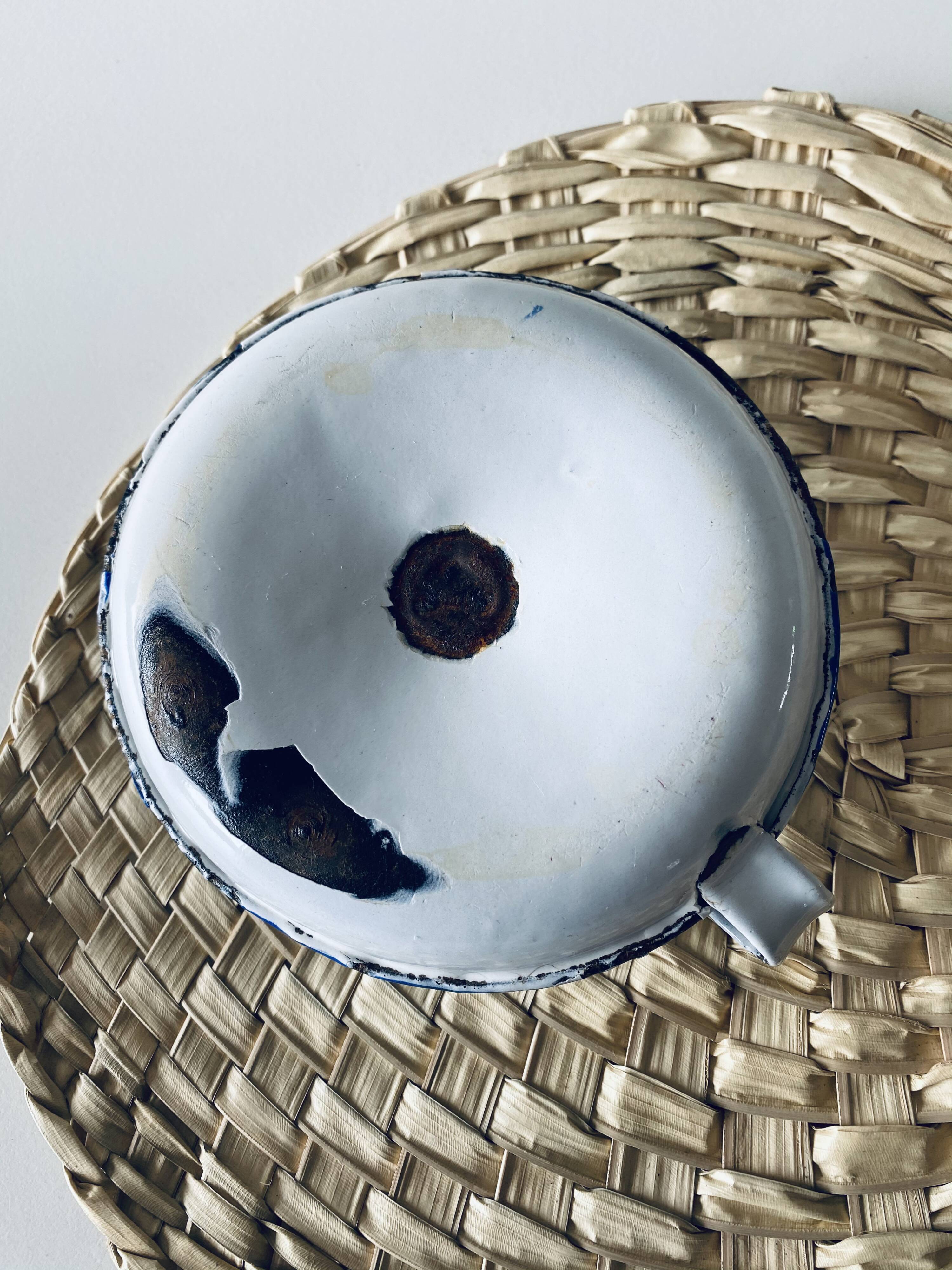 Old enamelled metal candlestick