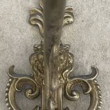 Adjustable wall light in brass and gold metal.