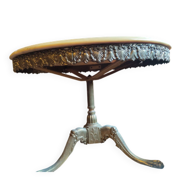 Round coffee table with a brass frame.