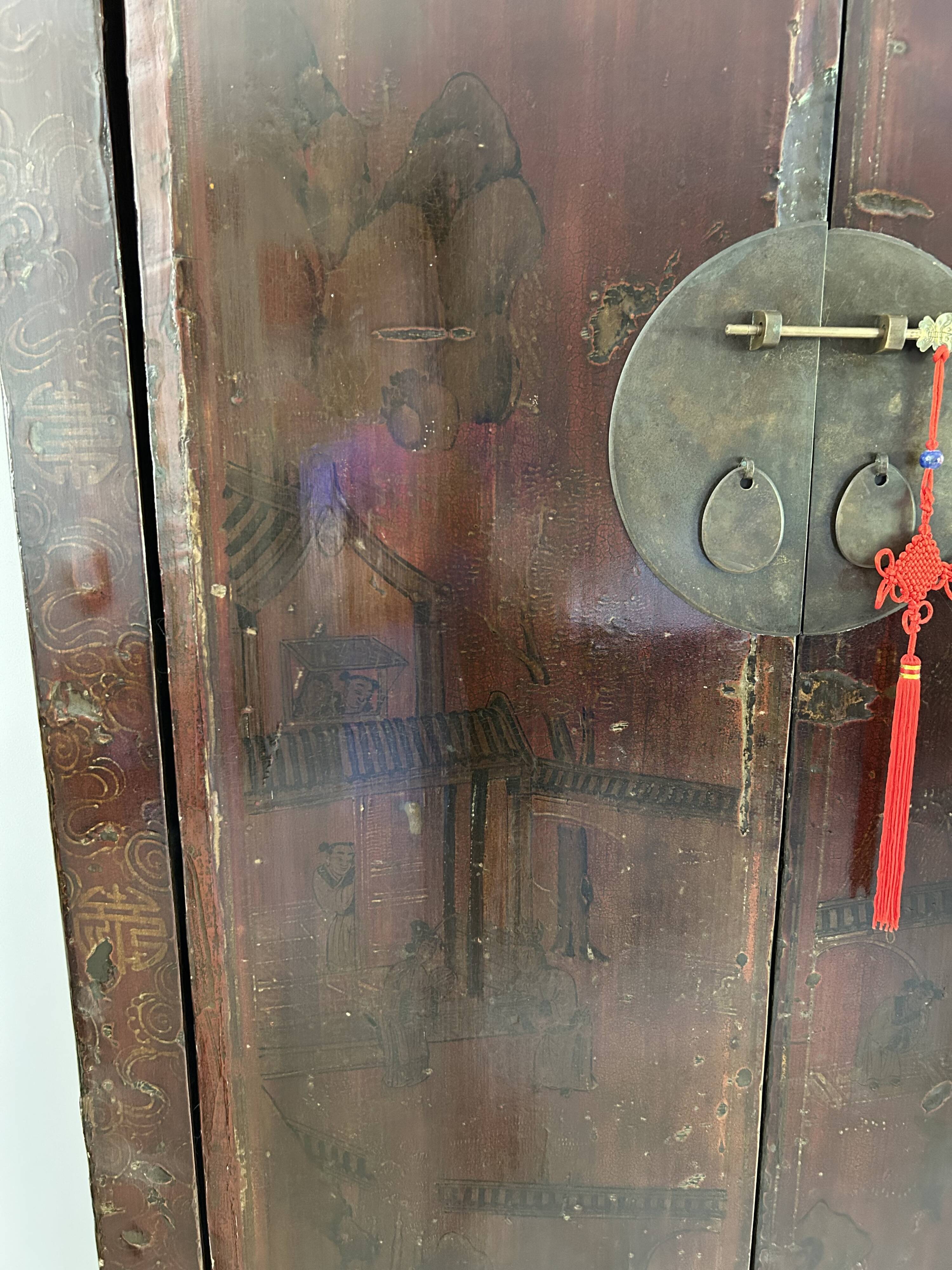 Antique Chinese wardrobe in carved elm.