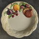 Vintage plate in ceramic enamelled decoration of fruits in relief
