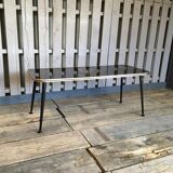 Vintage black and gold glass coffee table with conical legs from the 1940s.