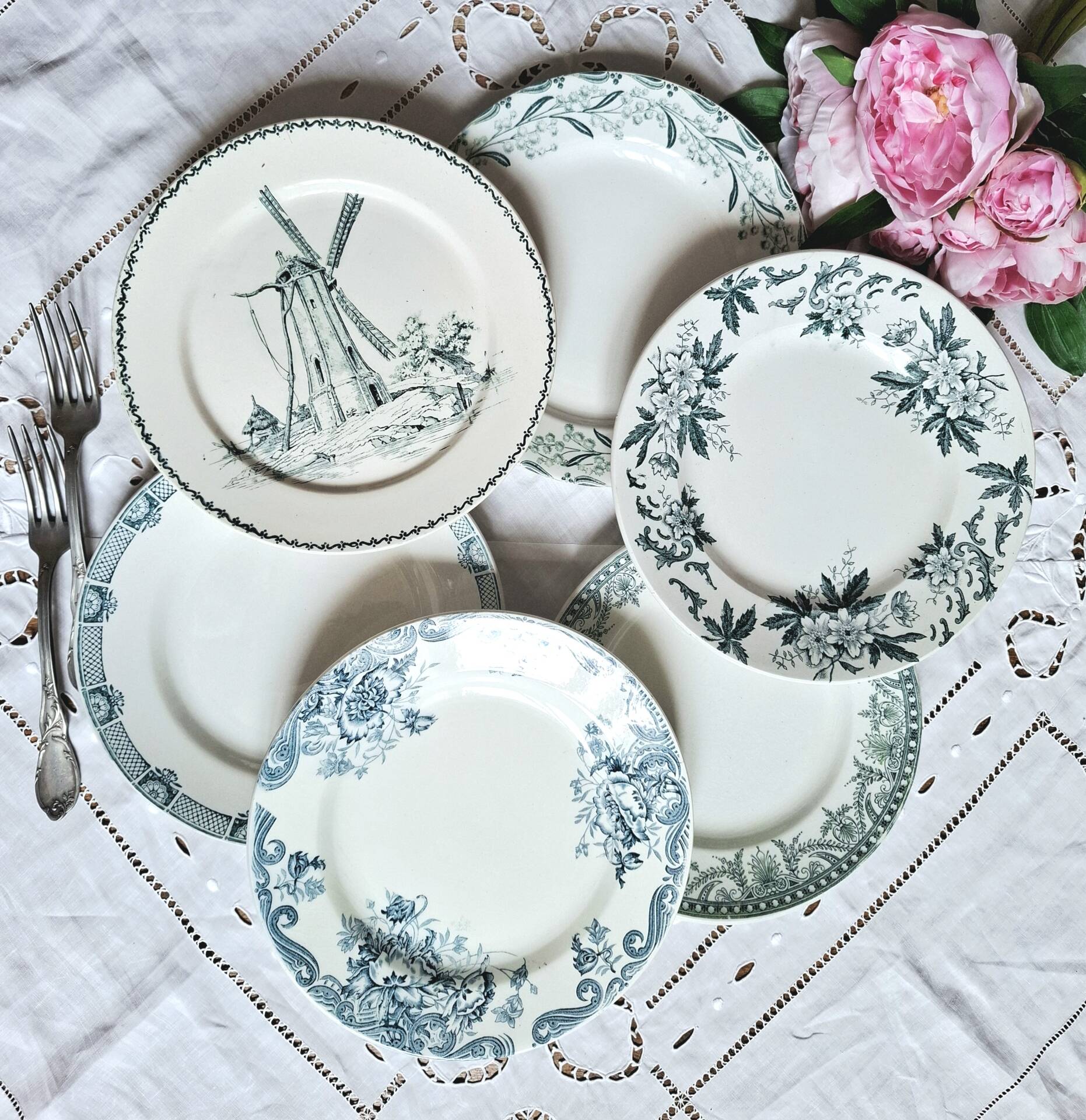 Old mismatched flat plates made of ironstone earthenware.