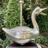 Old vintage lamp representing a duck in silver metal with wooden base