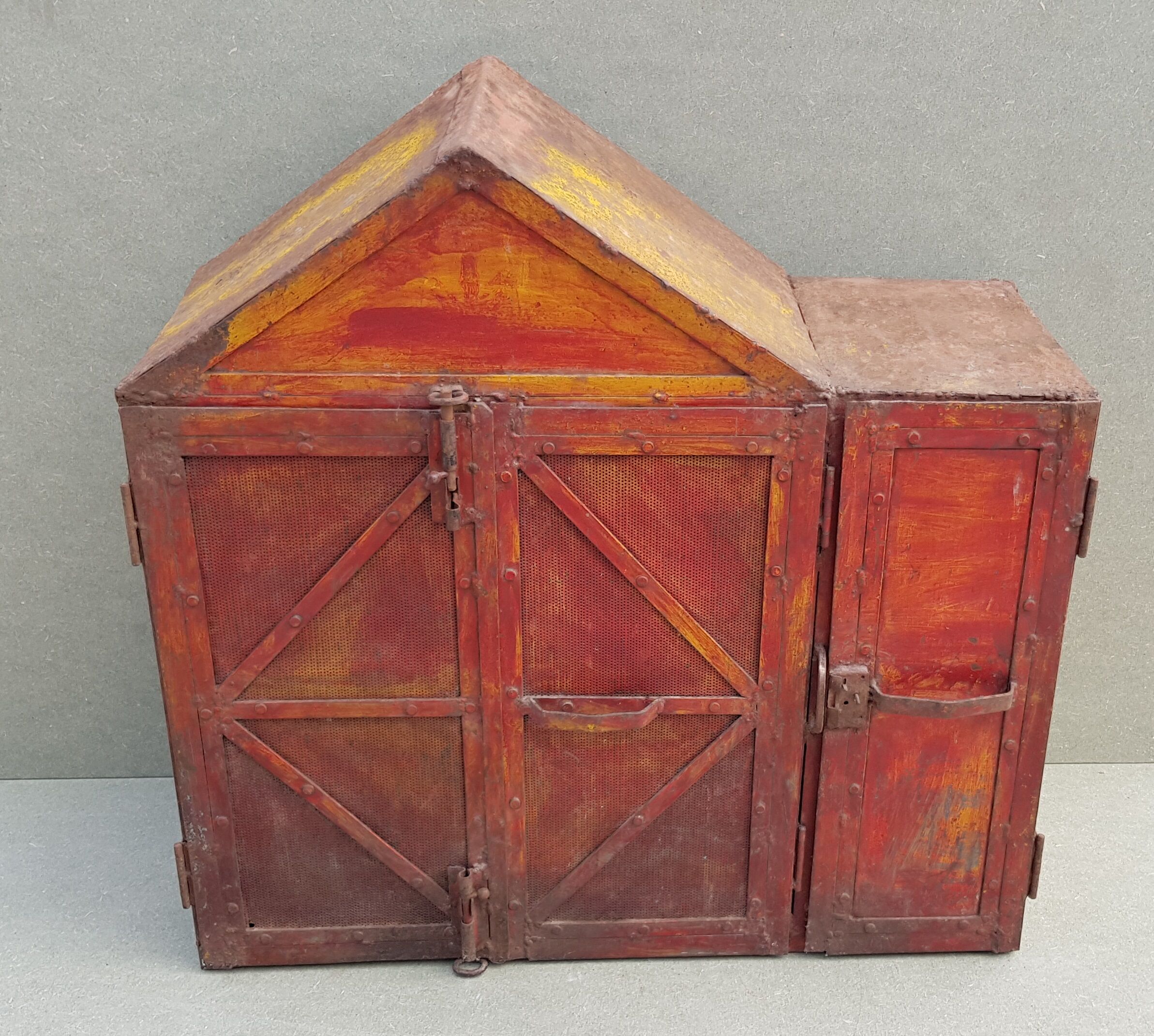 Old atypical metal workshop furniture with its original red patina