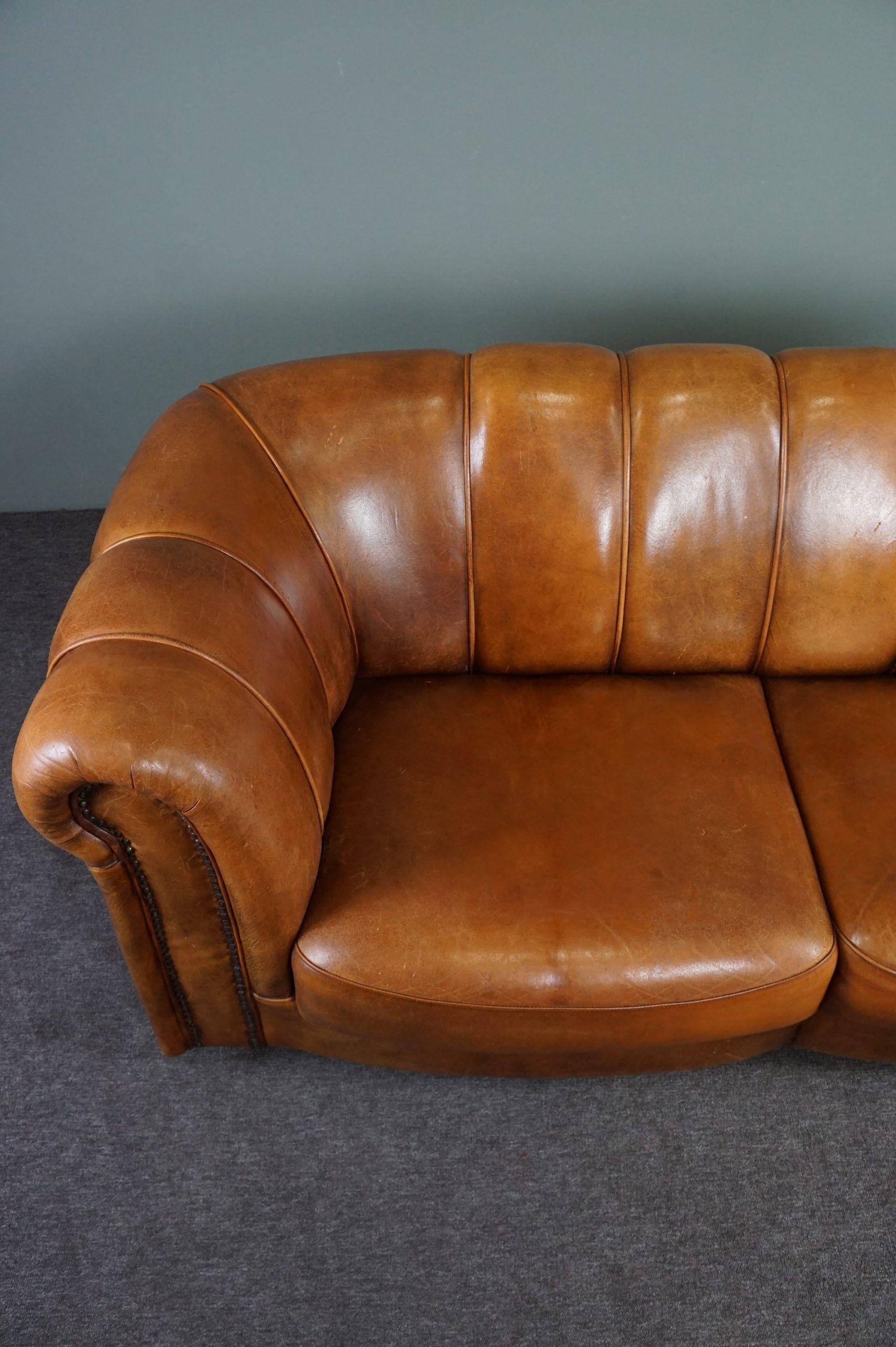 Sheepskin sofa with decorative nails