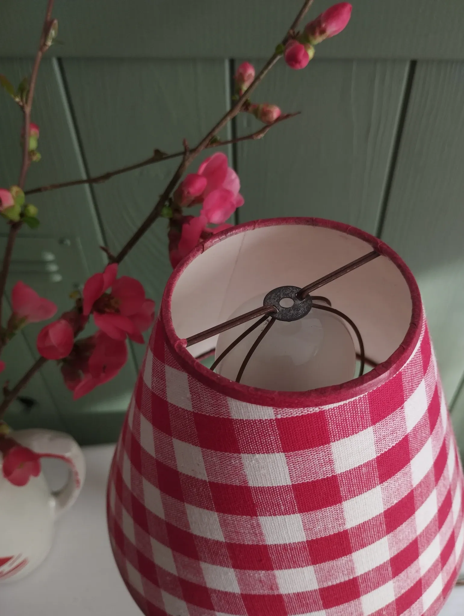 Pair of small lamps in gilded bronze by Petitot and red gingham lampshades.