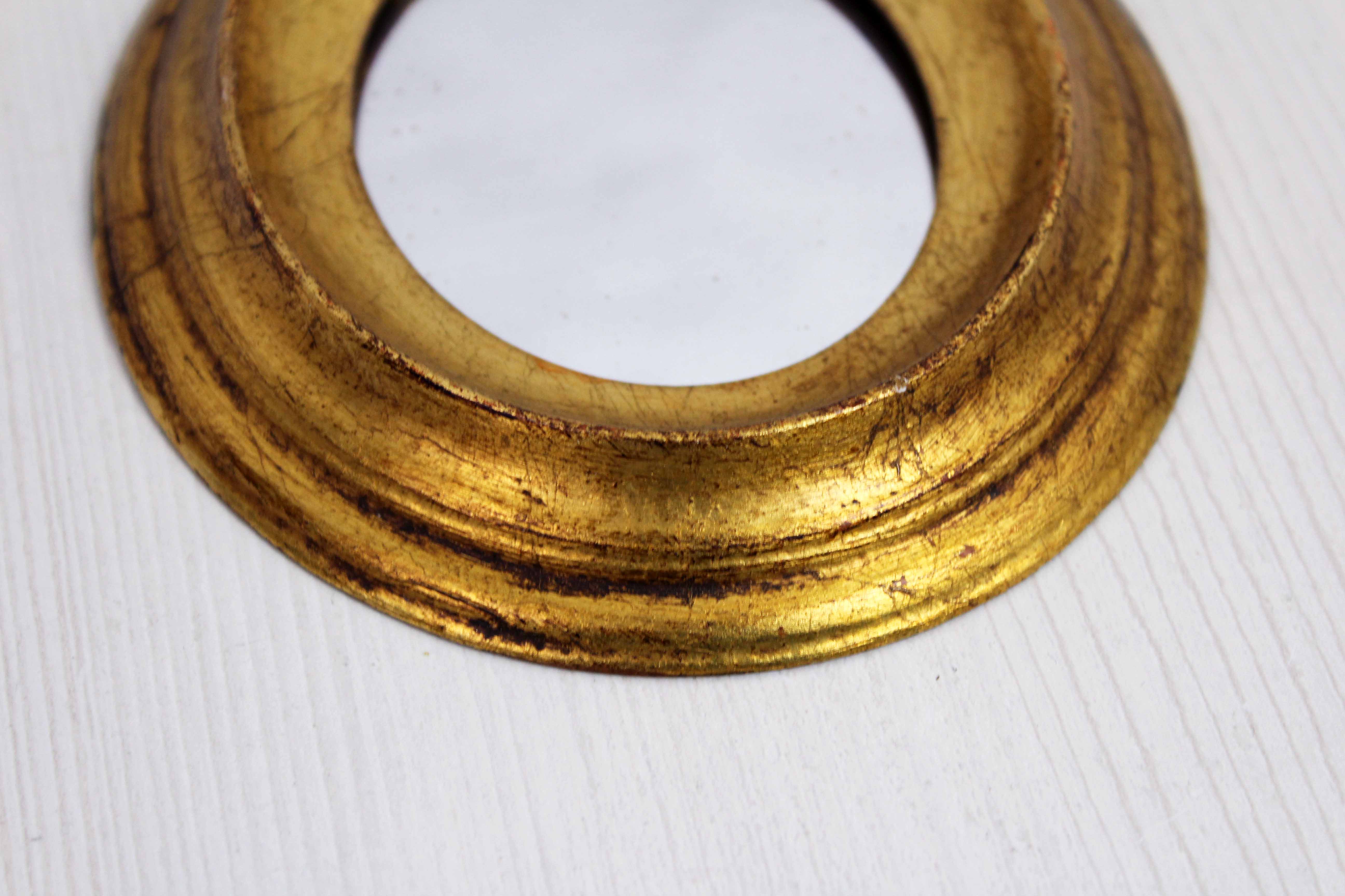 Golden oval mirror
