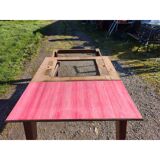 1960s oak dining table with integrated extensions.