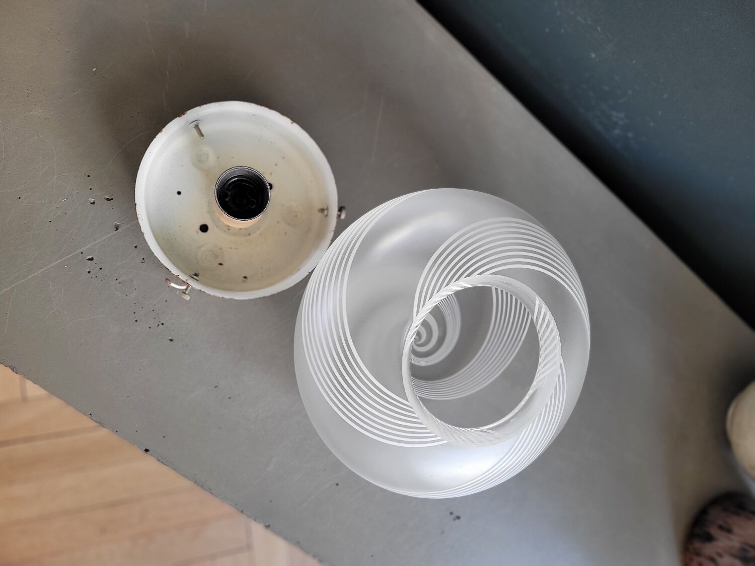 Frosted glass globe ceiling light with spiral patterns.